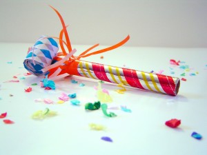 colorful party noisemaker and confetti