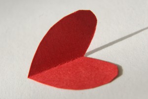 red paper folded into a heart shape