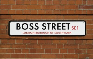 white sign on red brick wall with text that says Boss Street SE1 London Borough of Southwark