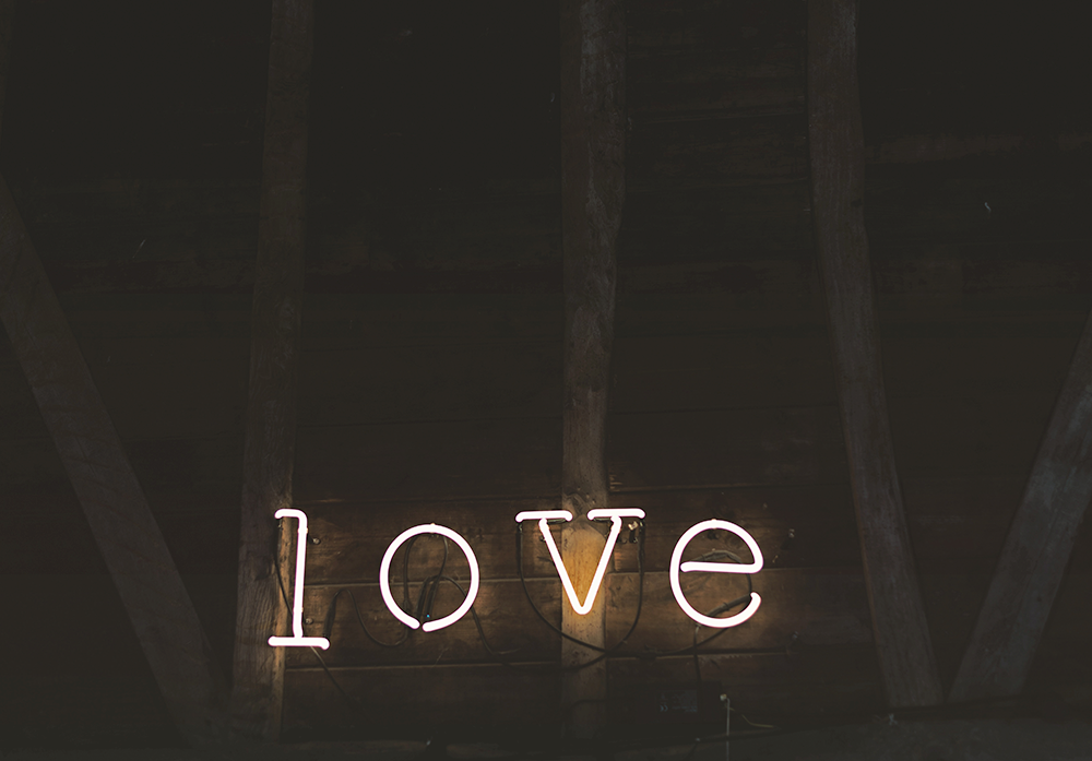 yellow neon sign that says love