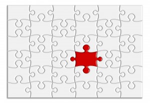 blank white puzzle with one red puzzle piece in the middle