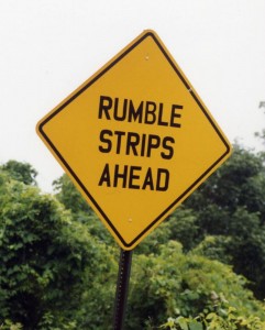 yellow road sign that says Rumble Strips Ahead