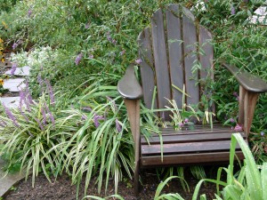 wooden lawn chair in bushes