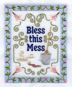 embroidery that says Bless This Mess with floral imagery and a mop and bucket