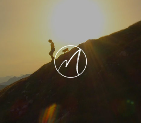 person and dog climbing down mountainside at sunrise with Martha Beck logo
