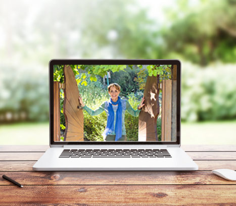 laptop on wooden desk displaying image of Martha Beck in blue scarf standing outside