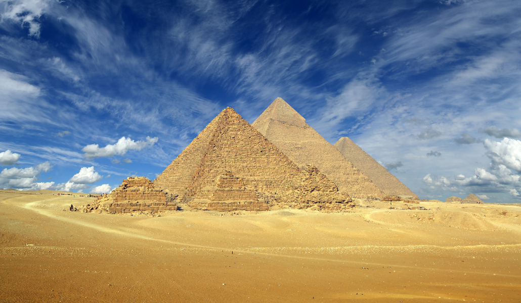 Pyramids of Giza under a blue sky