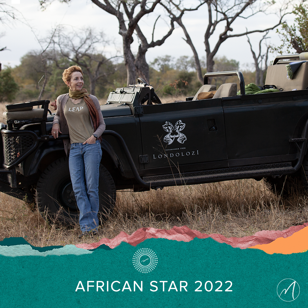 African Star 2022 logo on image of Martha Beck leaning on Londolozi jeep outside