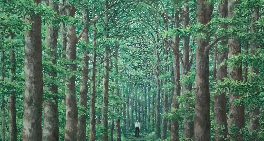 painting of person standing far away in dense forest