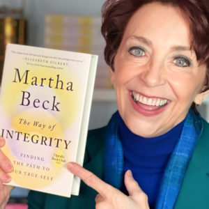 Martha holding The Way of Integrity with an Oprah Book Club seal.