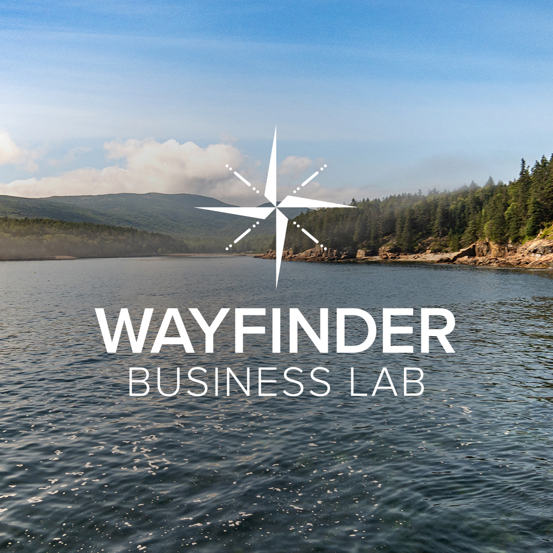 Wayfinder Business Lab and compass against a shoreline